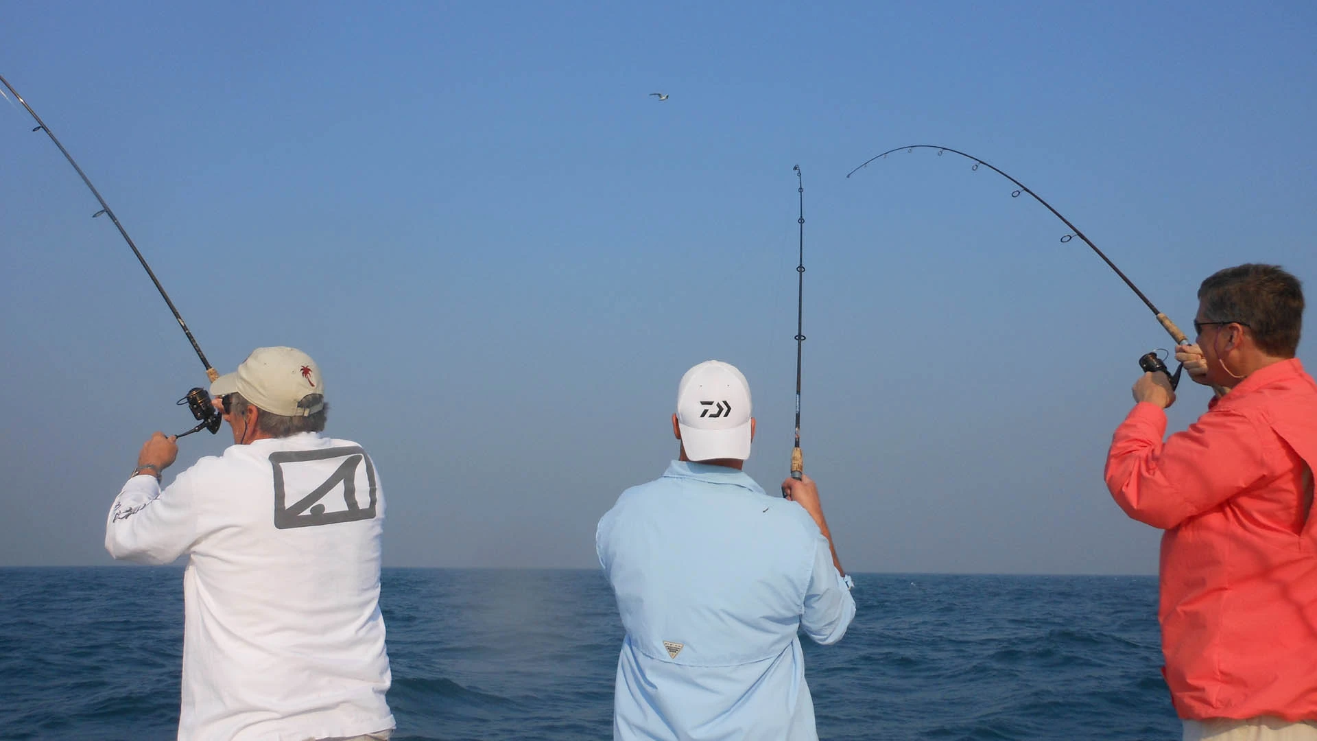 Three men deep sea tournament fishing in St. Petersburg, FL.